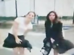 Two babes having problems with the windy weather