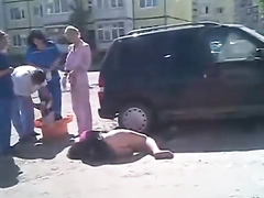 Drunken girl lies on the road with her ass naked