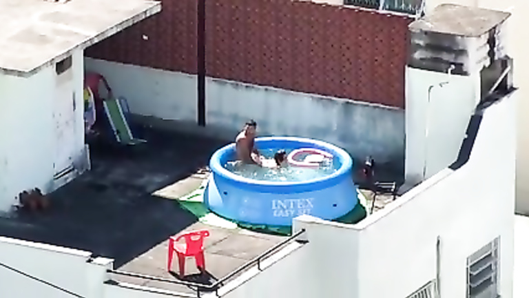 My horny neighbors caught having sex in the pool voyeurstyle image