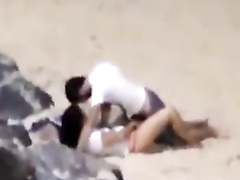 Italian lovers having missionary sex on the beach