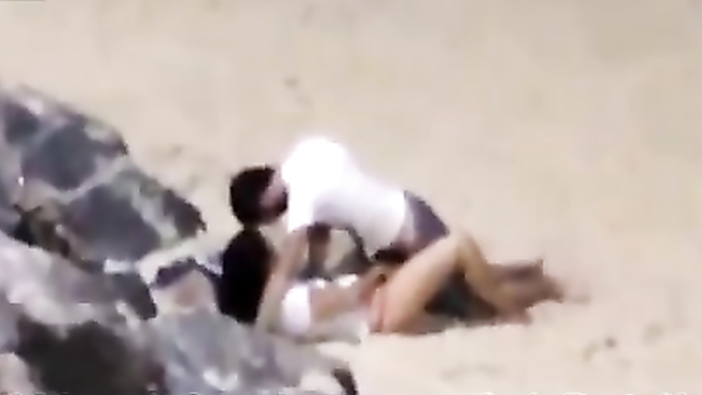 Italian lovers having missionary sex on the beach