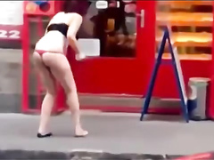 Drunk woman lifts up her skirt and brakes the door glass with her foot