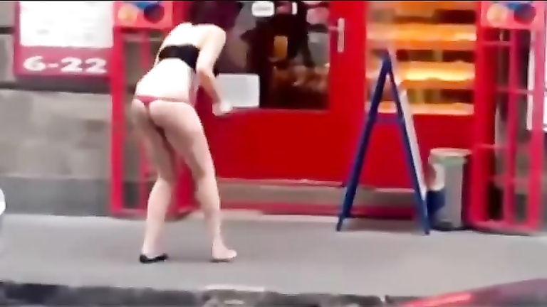 Drunk woman lifts up her skirt and brakes the door glass with her foot