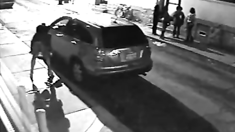 NYC prostitute hides behind a big car to relieve her bladder
