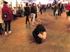 Brave blonde urinates on the middle of the crowded street!