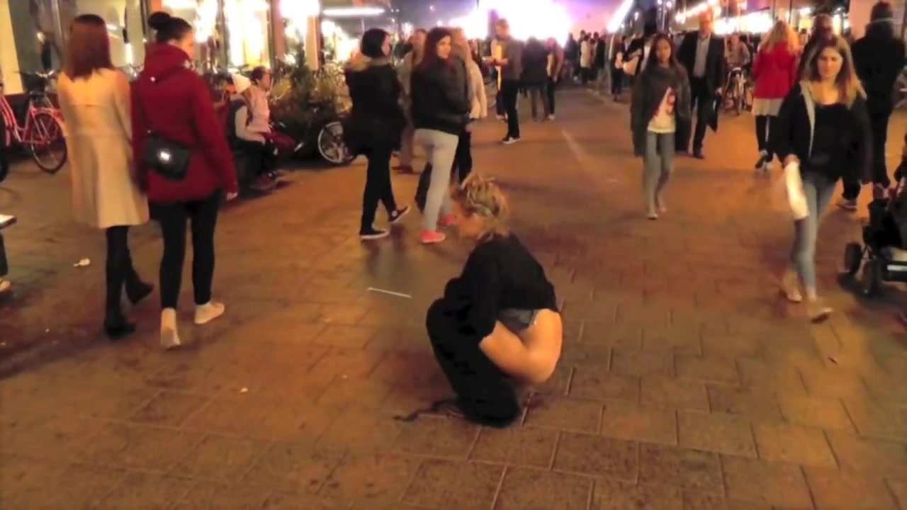 Brave blonde urinates on the middle of the crowded street! voyeurstyle