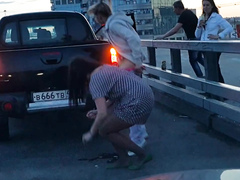 Russian chick shields her friend while she is peeing in the street