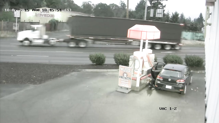 Desperate traveler soaks the road asphalt at the gas station