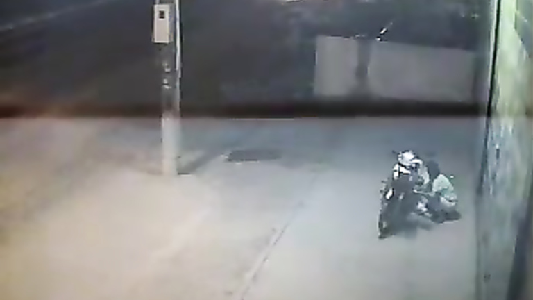 Female motorcyclist gets caught on security cam urinating