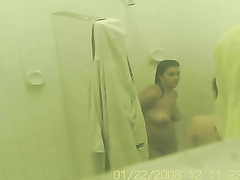 Two good looking babes get caught on camera showering