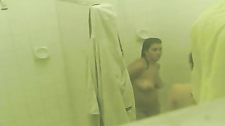 Two good looking babes get caught on camera showering