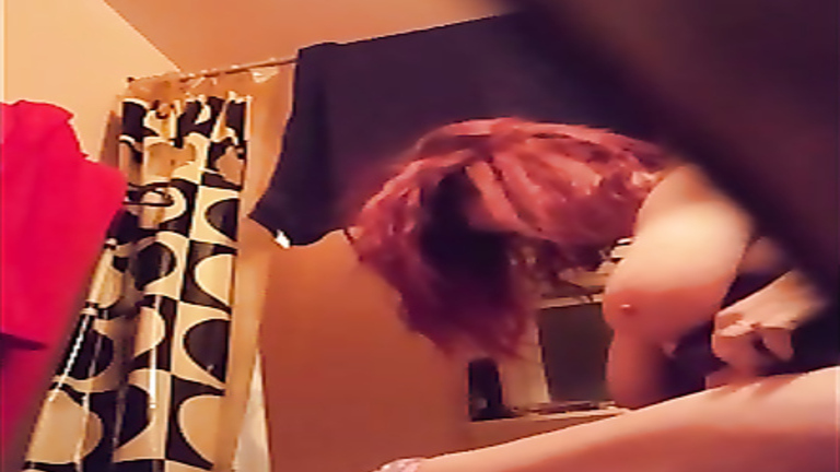 Nerdy redhead cougar changes her clothes in the bathroom