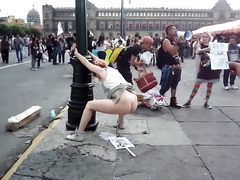 Female protester poops on a poster of someone and smears it with her hand