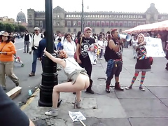 Female agitator pees and poops on a poster at a rally in protest to the government