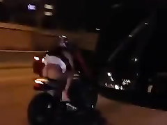 Brazilian girl has her skirt lifted up while riding on a bike