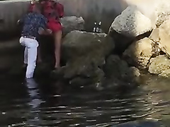 Drunk Spanish couple enjoys kissing in the bed of a river