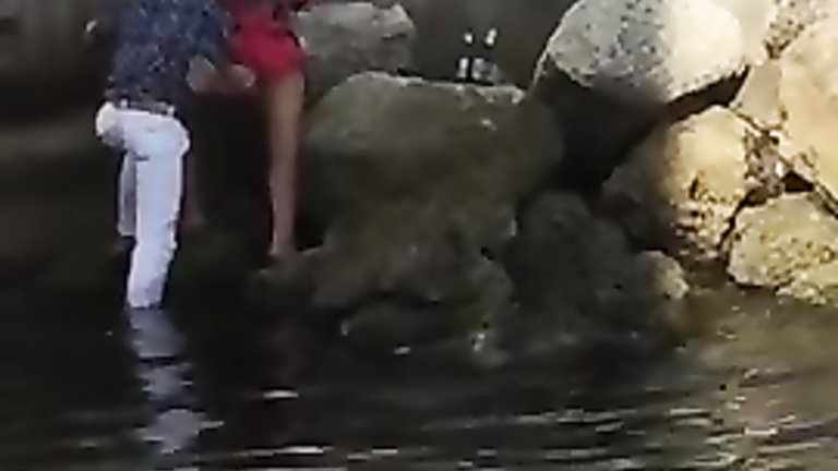 Drunk Spanish couple enjoys kissing in the bed of a river