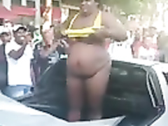 Big black mama strips down while standing in a cabriolet