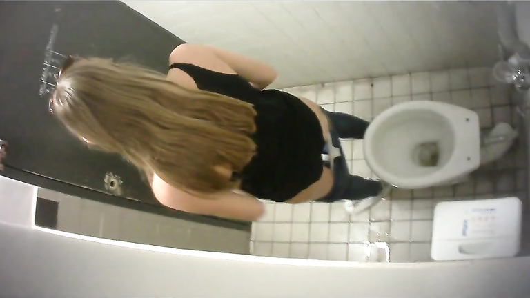 Slim long-haired brunette takes a quick whiz in the restroom