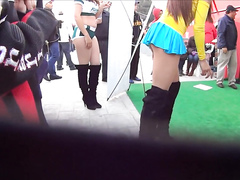 Cute model in a miniskirt mingles with people while being filmed