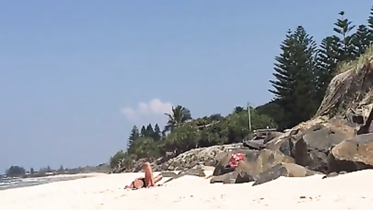 Man jerks off his little cock on a sexy woman at the beach