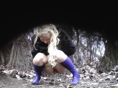 Slutty blonde in blue boots pees in the middle of the public park