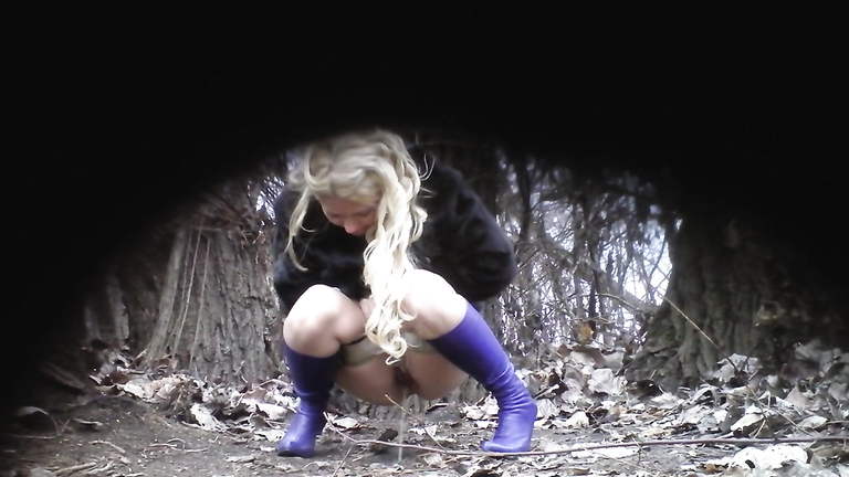 Slutty blonde in blue boots pees in the middle of the public park