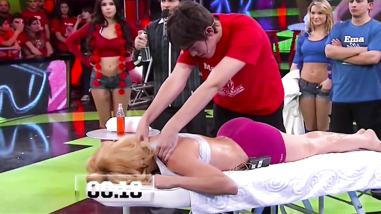 Athletic lady receives a massage live on the television