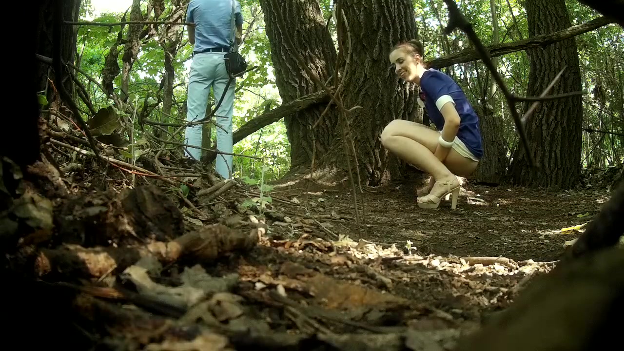 Guy stands on guard as his girlfriend pees behind a tree voyeurstyle image