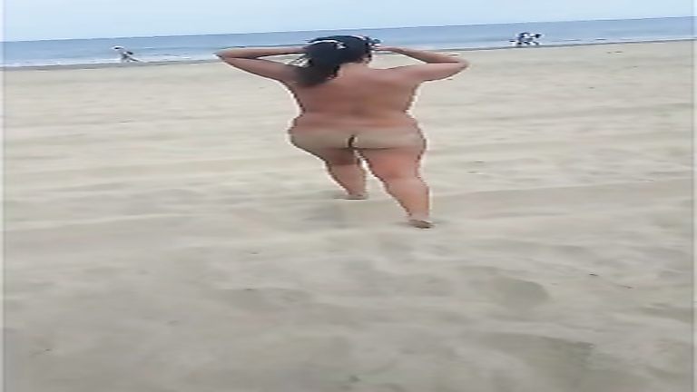 Curvaceous mature filly walks around the beach while being naked