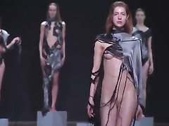 Fashion models drop balloons filled with water on the catwalk