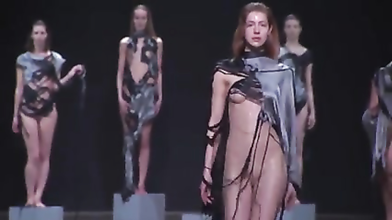 Fashion models drop balloons filled with water on the catwalk