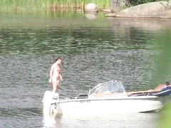 Nudist couple has fun in the middle of a beautiful lake
