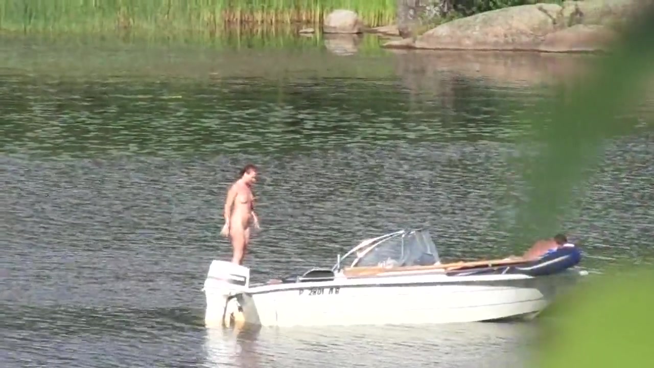 Nudist couple has fun in the middle of a beautiful lake voyeurstyle photo