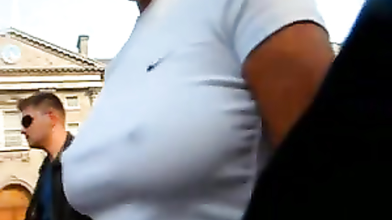 Braless brunette filmed on the street with her hard nipples