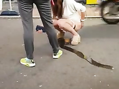 Korean girl pees on the street and gets taped