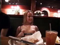 Exhibitionist girl shows her tits in the restaurant