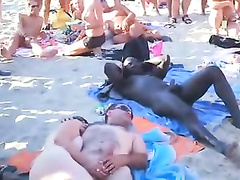 Nudist orgy at the beach with an audience