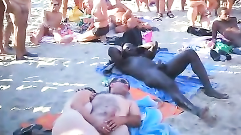 Nudist orgy at the beach with an audience