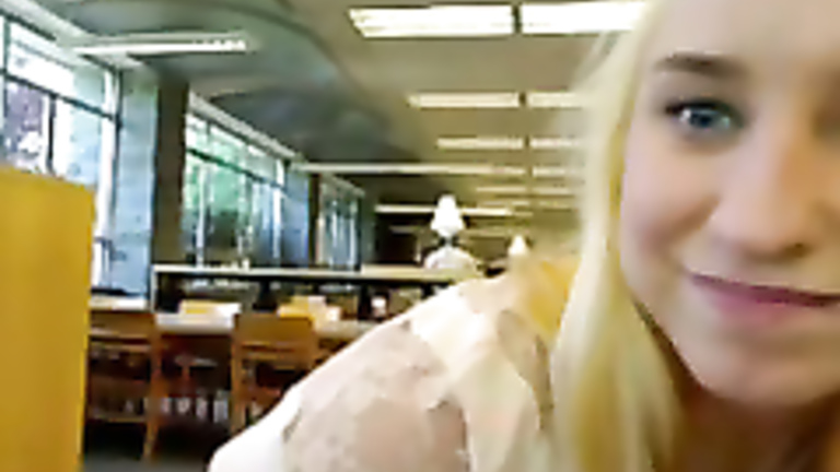 Shy girl toys her pussy in the library