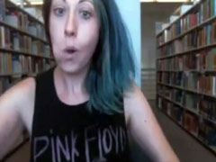 Funny babe in a tank top flashes tits in the library