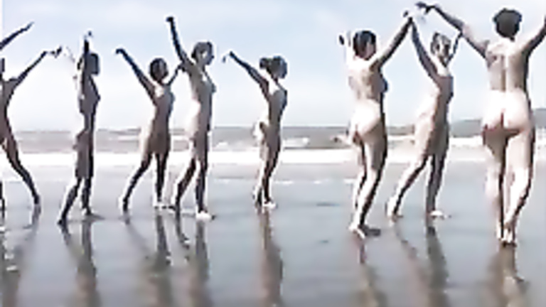 Naked performance art on the beach