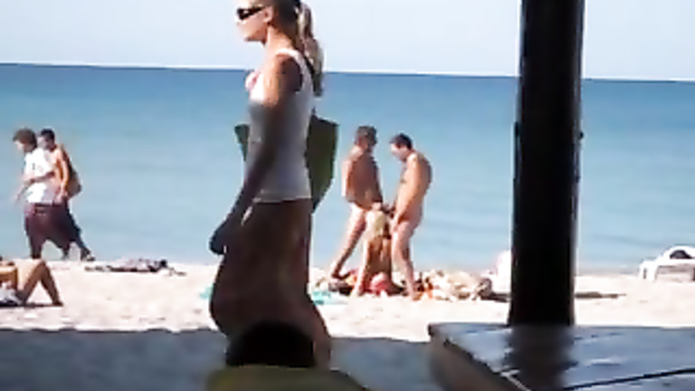 Craziest exhibitionist girl sucks two penises on the Crimean coast