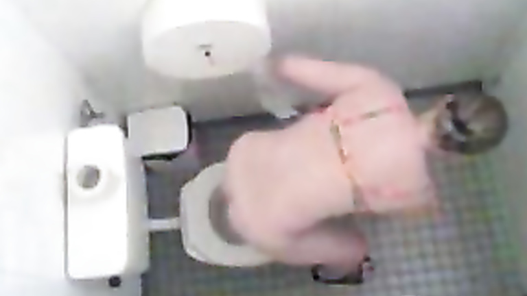 Pissing woman spied in a toilet by hidden camera