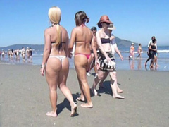 Filming bikini girls with hot butts on the beach