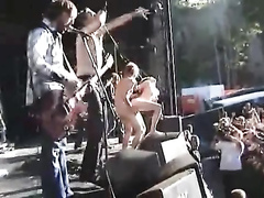 Hippies copulate on stage at a rock concert