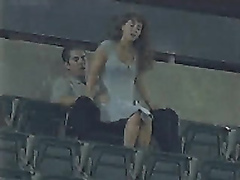 Horny friends make love in the high seats of the stadium