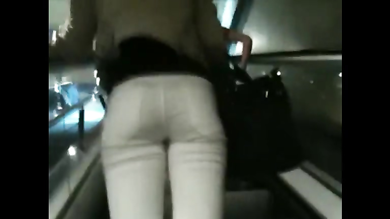 Hot woman's buttocks in thin white jeans