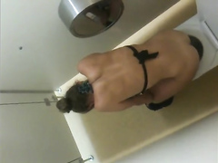Urinating bikini girl filmed over the restroom wall
