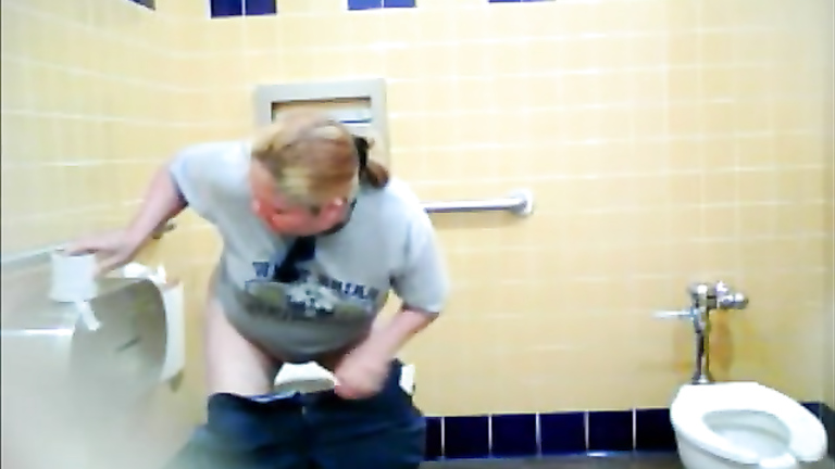 Chubby blonde uses the public toilet